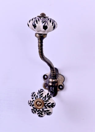 Black Design On White Base Ceramic Knob With Metal Wall Hanger