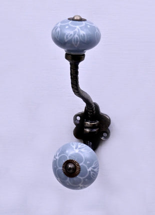 White Floral Pattern on Powder Blue With Metal Wall Hanger