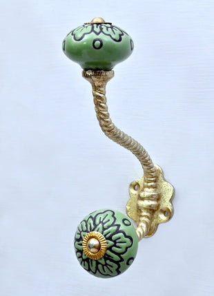 Black Design on Green Ceramic Knob With Metal Wall Hanger