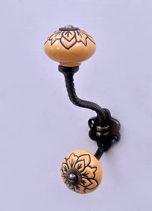 Black Design on Yellow Ceramic Knob With Metal Wall Hanger