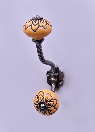 Black Design on Yellow Ceramic Knob With Metal Wall Hanger