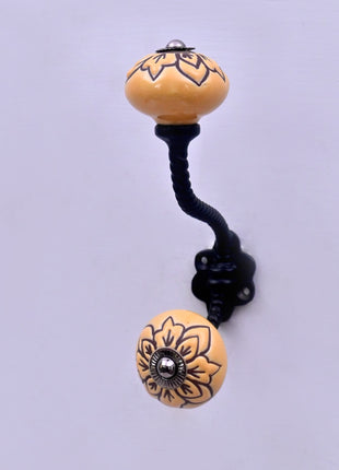 Black Design on Yellow Ceramic Knob With Metal Wall Hanger