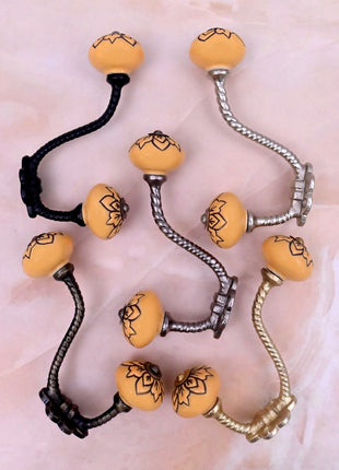 Black Design on Yellow Ceramic Knob With Metal Wall Hanger