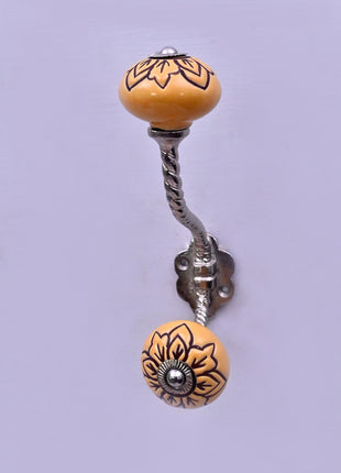 Black Design on Yellow Ceramic Knob With Metal Wall Hanger