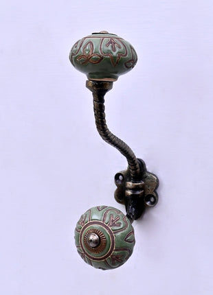 Dark Brown Design on Green Ceramic Knob With Metal Wall Hanger