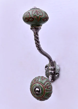 Dark Brown Design on Green Ceramic Knob With Metal Wall Hanger
