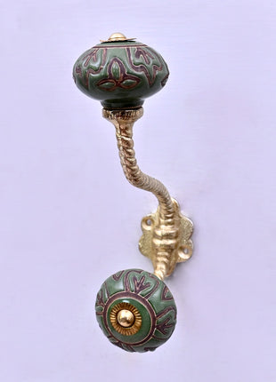 Dark Brown Design on Green Ceramic Knob With Metal Wall Hanger