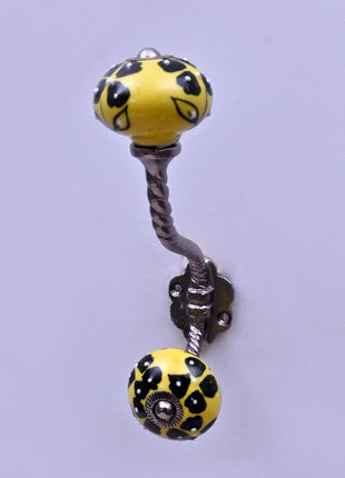 Black Flowers Design on Yellow Base Ceramic Knob With Metal Wall Hanger