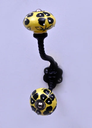 Black Flowers Design on Yellow Base Ceramic Knob With Metal Wall Hanger