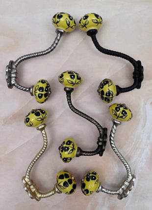 Black Flowers Design on Yellow Base Ceramic Knob With Metal Wall Hanger