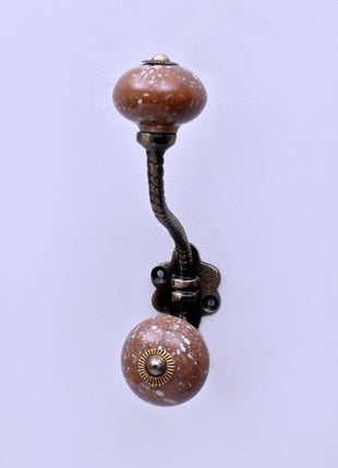 White Speckled Pattern on Rustic Brown Ceramic Knob With Metal Wall Hanger