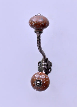 White Speckled Pattern on Rustic Brown Ceramic Knob With Metal Wall Hanger