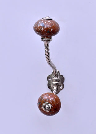 White Speckled Pattern on Rustic Brown Ceramic Knob With Metal Wall Hanger