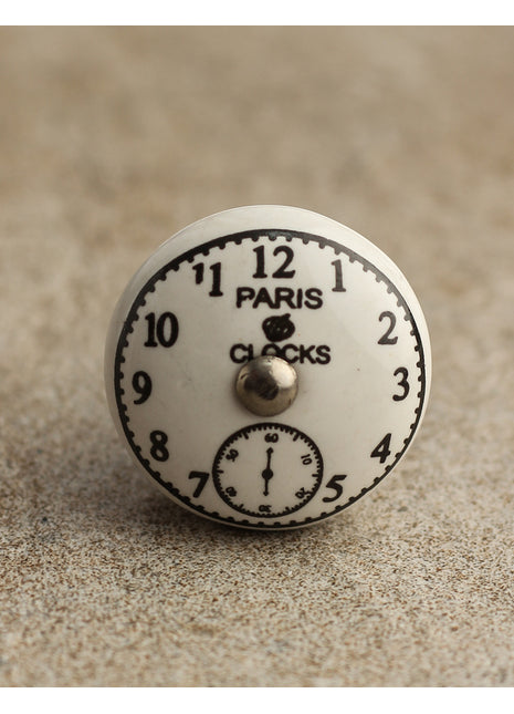 Black Clock on a White Ceramic Cabinet Knob