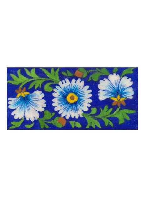 turquoise & white flower with green leaves on blue tile