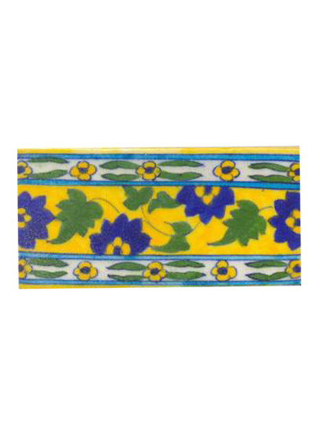 Blue flower and green leaves with yellow tile