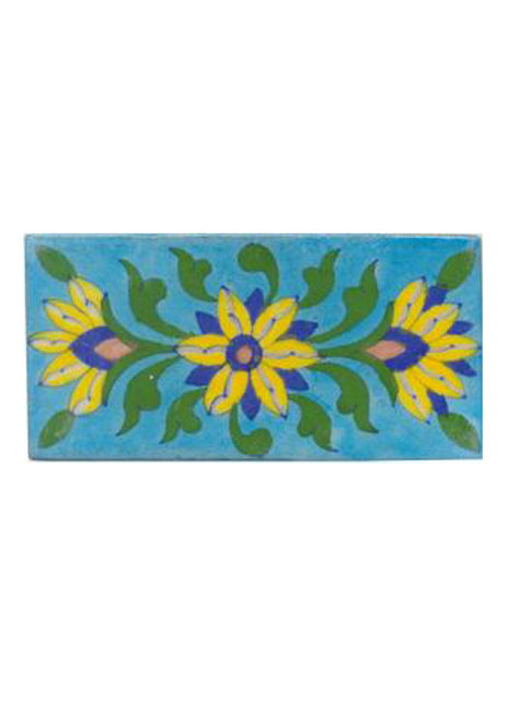 Three yellow,blue,brown and green leaves with turqouise tile