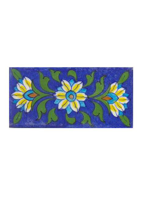 Three yellow and turqouise flower and green leaves with blue tile
