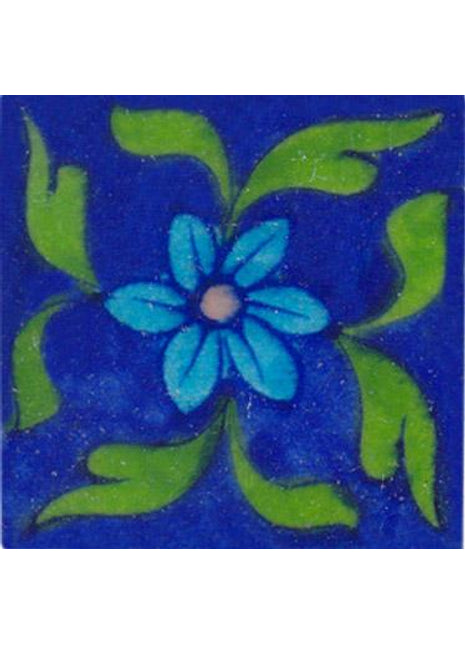 Turquoise flower and green leaves on blue tile