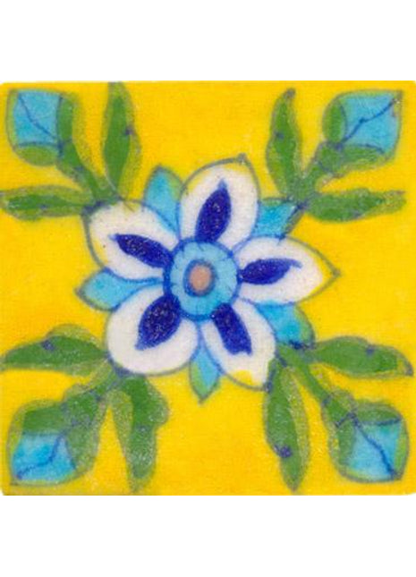 white, blue and turquoise flower wih green leaves on yellow tile