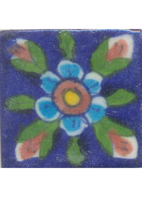 Turquoise Flowers With Brown and Yellow Center and green Leaves On Blue Tile