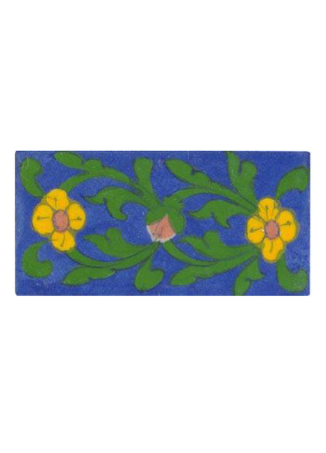 yellow flower with green leaves on blue tile