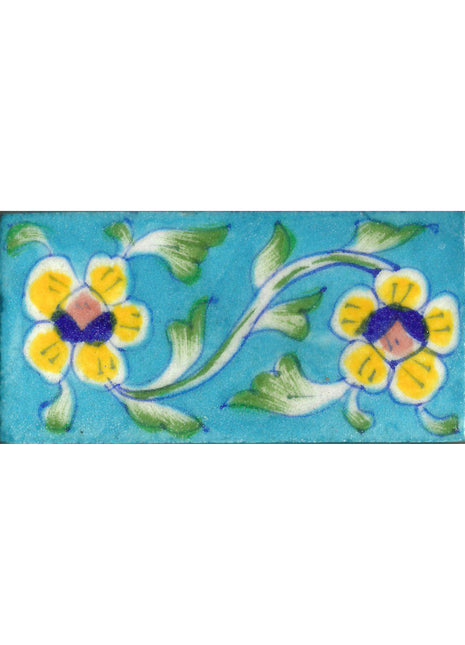 Two Yellow Flowers With Green leaves On Turquoise Base Tile