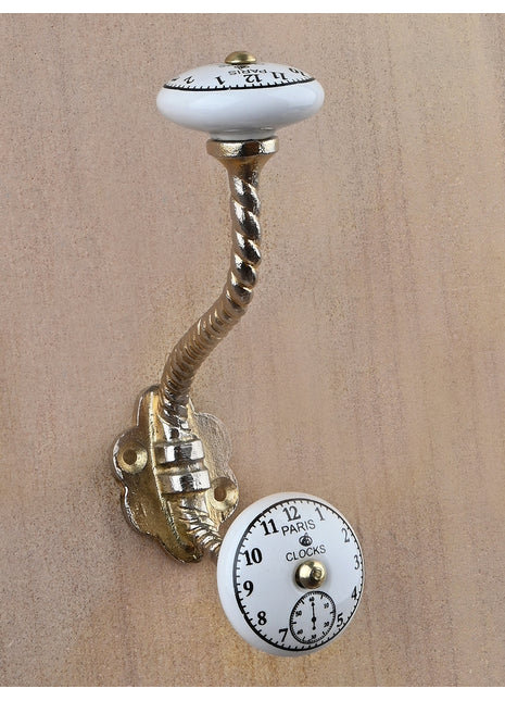 Black Clock on a White Ceramic Knob With Metal Wall Hanger