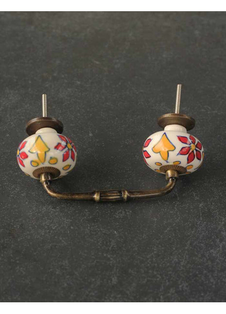 Red and Yellow Flower Design on a White Cabinet Pull