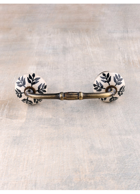 White Ceramic Bathroom Cabinet Pull With Black Petal Stem Design