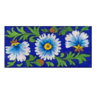 turquoise & white flower with green leaves on blue tile