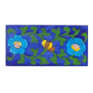 Two turqouise flower and green leaves with blue tile