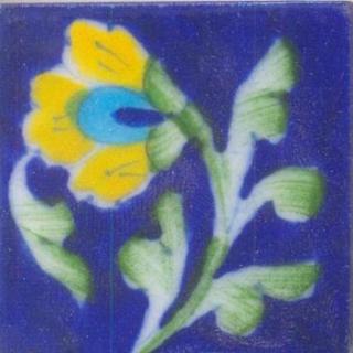 Yellow, turquoise flower with green floral on blue tile