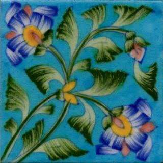Two Blue flowers with green leaves on turquoise tile