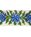 white, blue turquoise flower and green leaves on white tile